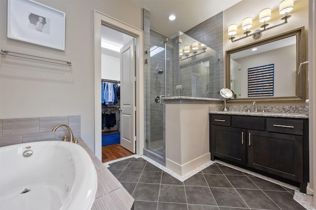 3909 Rose St, Houston, TX 77007 - full bathroom with a stall shower, tile patterned floors, a jetted tub, vanity, and a spacious closet