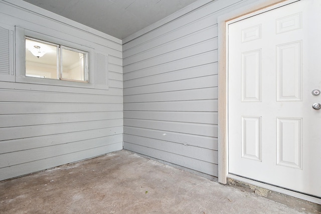44 Farrell St, Houston, TX 77022 - empty room with unfinished concrete floors and wood walls