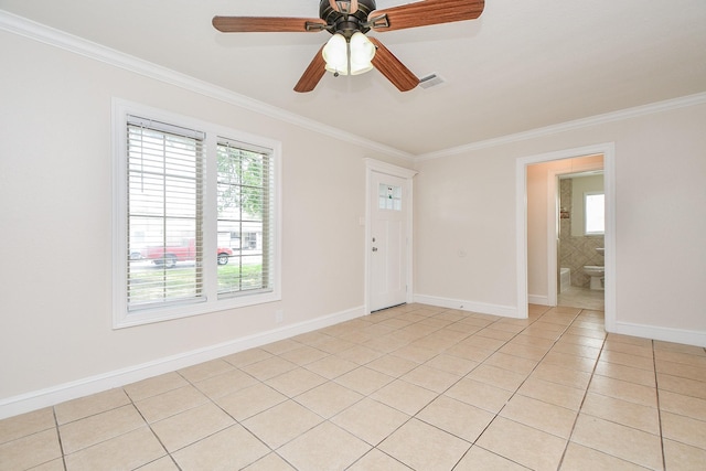 44 Farrell St, Houston, TX 77022 - unfurnished room with ornamental molding, healthy amount of natural light, light tile patterned flooring, and baseboards