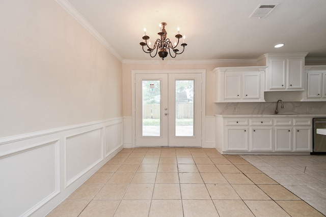 44 Farrell St, Houston, TX 77022 - doorway to outside with a chandelier, a sink, light tile patterned floors, french doors, and crown molding