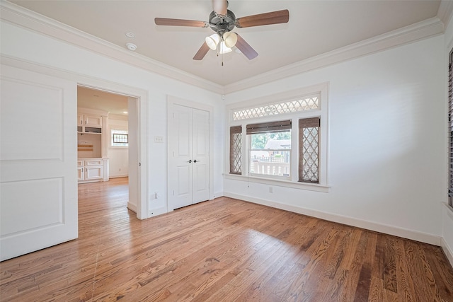 901 W 21st St, Houston, TX 77008 - unfurnished bedroom featuring crown molding, light wood-style floors, baseboards, a closet, and a ceiling fan