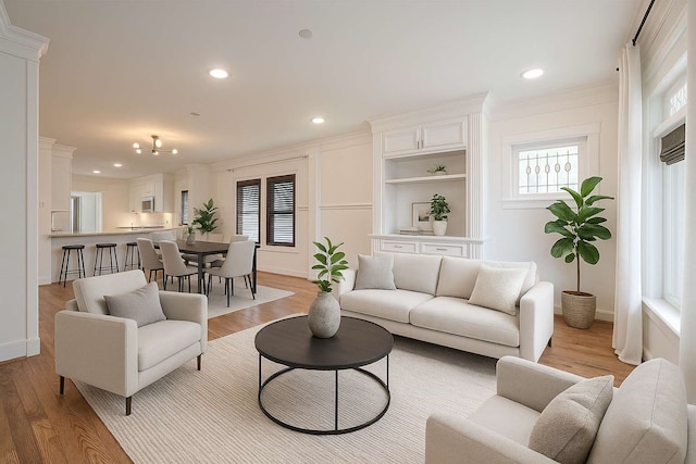 901 W 21st St, Houston, TX 77008 - living area featuring light wood-type flooring, recessed lighting, and ornamental molding
