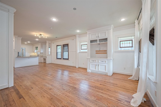901 W 21st St, Houston, TX 77008 - unfurnished living room featuring healthy amount of natural light, light wood-style floors, crown molding, and recessed lighting