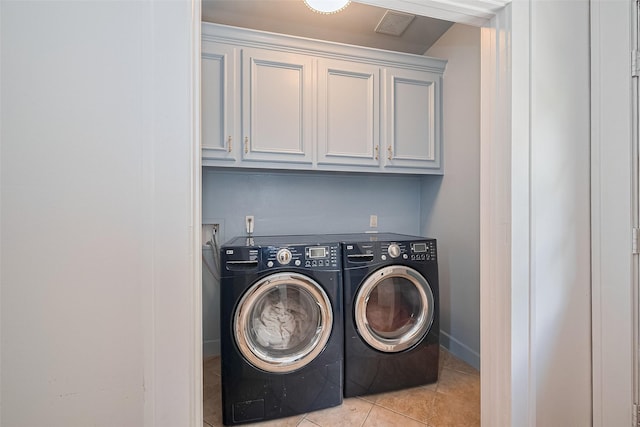 901 W 21st St, Houston, TX 77008 - laundry room with washing machine and clothes dryer, cabinet space, and light tile patterned flooring