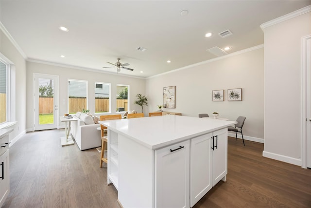 1816 Rosedale St, Houston, TX 77004 - kitchen featuring open shelves, dark wood-type flooring, crown molding, white cabinets, and open floor plan