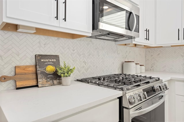 1816 Rosedale St, Houston, TX 77004 - kitchen featuring appliances with stainless steel finishes, decorative backsplash, and white cabinets