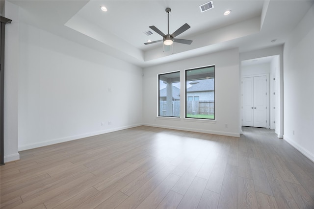 825 Coronado Terrace Ln, Katy, TX 77493 - empty room with a tray ceiling, light wood-style floors, a ceiling fan, and recessed lighting
