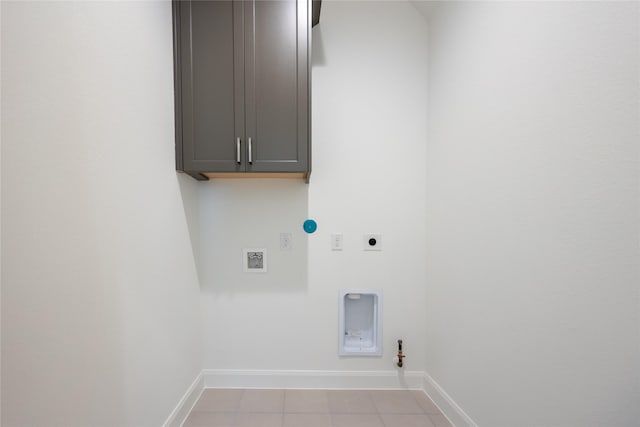 825 Coronado Terrace Ln, Katy, TX 77493 - washroom with hookup for a gas dryer, cabinet space, hookup for an electric dryer, light tile patterned floors, and hookup for a washing machine