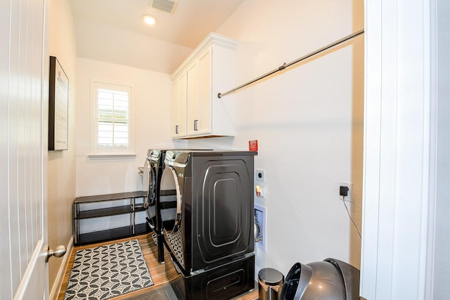 2234 Clements Shore Ln, La Porte, TX 77571 - laundry area with cabinet space, separate washer and dryer, wood finished floors, and baseboards