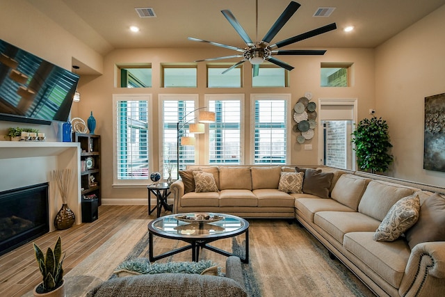 2234 Clements Shore Ln, La Porte, TX 77571 - living area featuring a glass covered fireplace, a ceiling fan, wood finished floors, recessed lighting, and baseboards