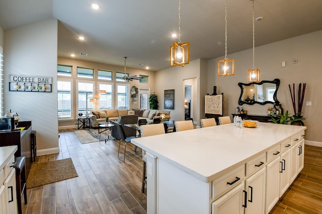 2234 Clements Shore Ln, La Porte, TX 77571 - kitchen featuring dark wood finished floors, a ceiling fan, a center island, recessed lighting, and baseboards