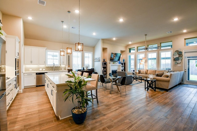 2234 Clements Shore Ln, La Porte, TX 77571 - kitchen featuring a sink, light countertops, light wood-style floors, a ceiling fan, and recessed lighting