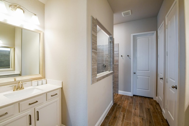 2234 Clements Shore Ln, La Porte, TX 77571 - bathroom with vanity, walk in shower, wood finished floors, and baseboards