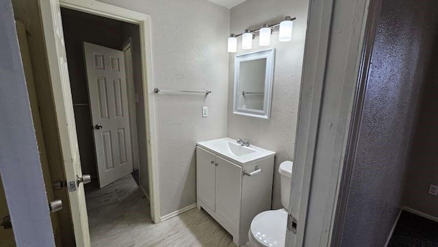 12107 Westwold Dr, Tomball, TX 77377 - bathroom featuring toilet, vanity, and a textured wall