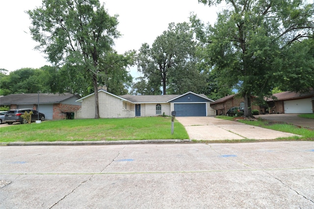 3911 Hermitage Hollow Ln, Houston, TX 77339 - view of front of property with a front lawn, an attached garage, concrete driveway, and brick siding