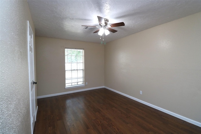 3911 Hermitage Hollow Ln, Houston, TX 77339 - spare room featuring dark wood finished floors, baseboards, a ceiling fan, and a textured ceiling