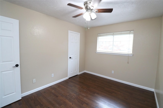 3911 Hermitage Hollow Ln, Houston, TX 77339 - unfurnished room with dark wood finished floors, ceiling fan, and baseboards