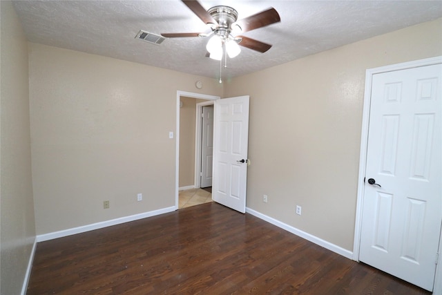 3911 Hermitage Hollow Ln, Houston, TX 77339 - unfurnished bedroom featuring wood finished floors, baseboards, a textured ceiling, and a ceiling fan