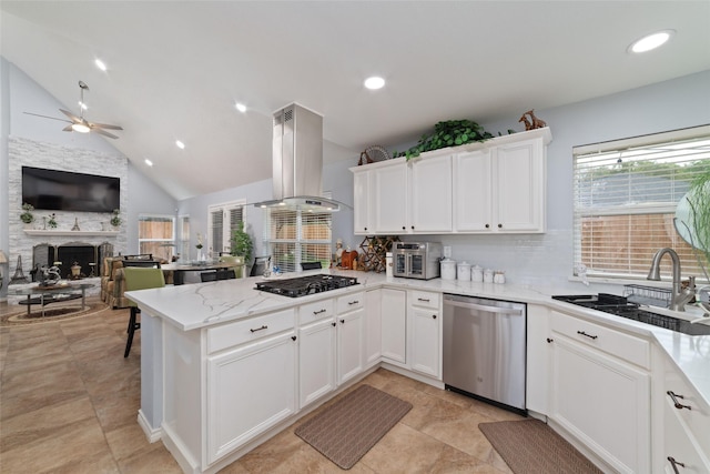 15607 Ensenada Dr, Houston, TX 77083 - kitchen with stainless steel dishwasher, island exhaust hood, black gas stovetop, a sink, and ceiling fan