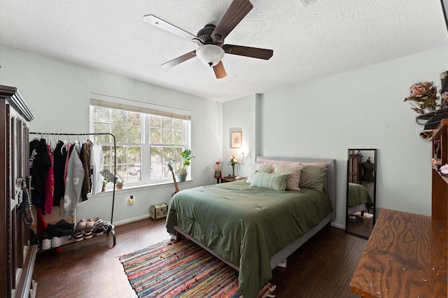 4807 Louisa Ct, Sugar Land, TX 77478 - bedroom with wood finished floors, ceiling fan, baseboards, and a textured ceiling