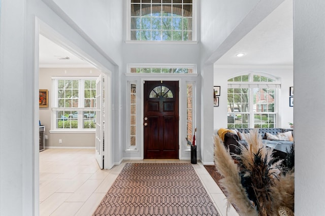 4807 Louisa Ct, Sugar Land, TX 77478 - foyer with crown molding, light tile patterned flooring, baseboards, a high ceiling, and recessed lighting