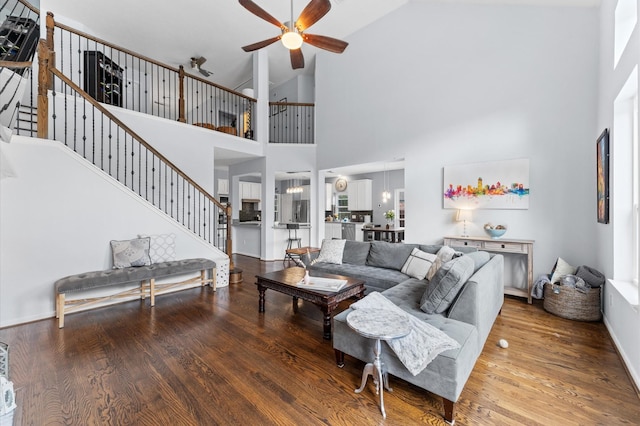 4807 Louisa Ct, Sugar Land, TX 77478 - living room with ceiling fan, wood finished floors, stairs, high vaulted ceiling, and baseboards