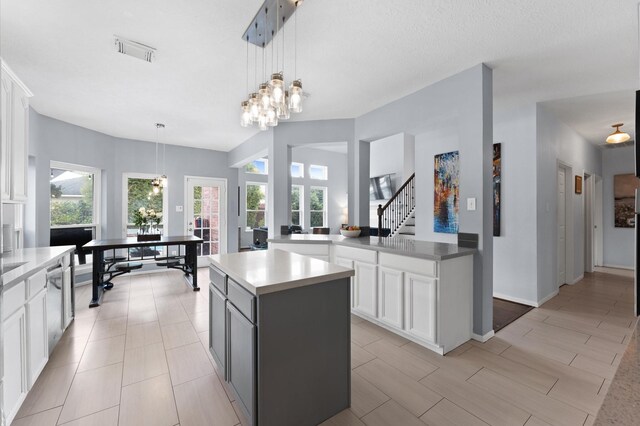 4807 Louisa Ct, Sugar Land, TX 77478 - kitchen featuring white cabinetry, a center island, hanging light fixtures, light countertops, and a chandelier
