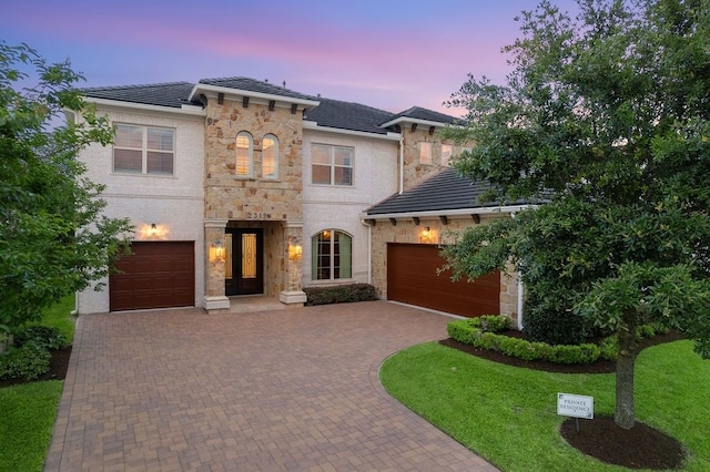 2319 Wyndam Heights Ln, Houston, TX 77077 - view of front of house featuring decorative driveway, stone siding, and an attached garage