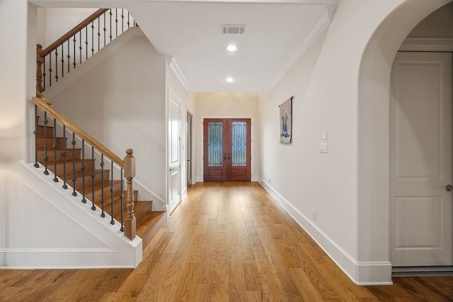 2319 Wyndam Heights Ln, Houston, TX 77077 - foyer featuring arched walkways, baseboards, stairs, french doors, and crown molding