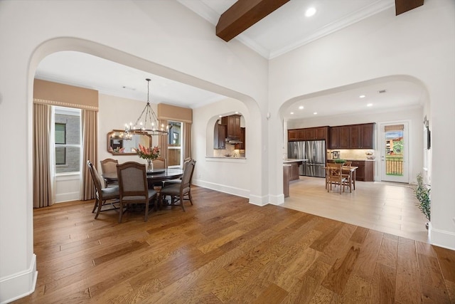 2319 Wyndam Heights Ln, Houston, TX 77077 - dining space with arched walkways, plenty of natural light, light wood-type flooring, ornamental molding, and beamed ceiling