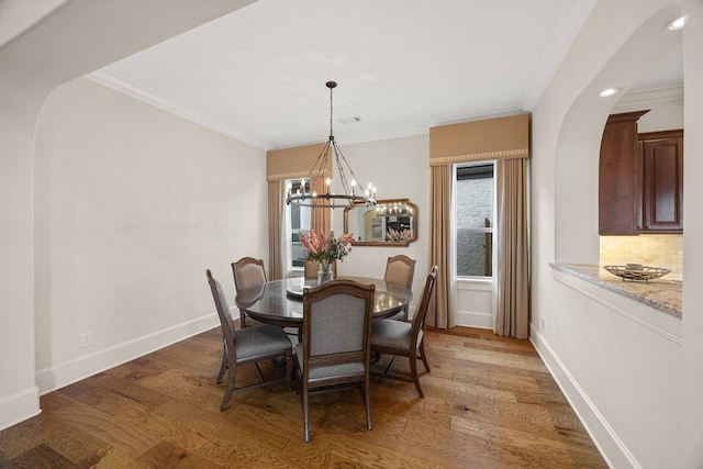 2319 Wyndam Heights Ln, Houston, TX 77077 - dining room with a chandelier, ornamental molding, baseboards, light wood-style floors, and arched walkways
