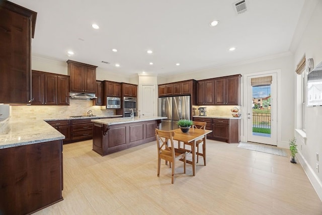 2319 Wyndam Heights Ln, Houston, TX 77077 - kitchen featuring stainless steel appliances, backsplash, under cabinet range hood, ornamental molding, and a center island with sink