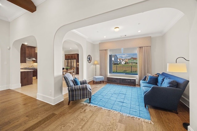 2319 Wyndam Heights Ln, Houston, TX 77077 - living room featuring arched walkways, light wood finished floors, ornamental molding, recessed lighting, and baseboards
