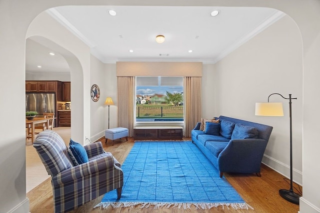 2319 Wyndam Heights Ln, Houston, TX 77077 - living room with arched walkways, baseboards, wood finished floors, crown molding, and recessed lighting