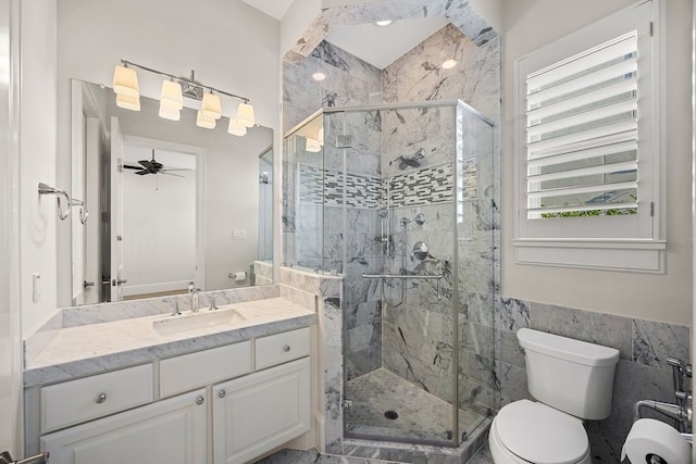 2319 Wyndam Heights Ln, Houston, TX 77077 - bathroom featuring vanity, toilet, a stall shower, tile walls, and ceiling fan
