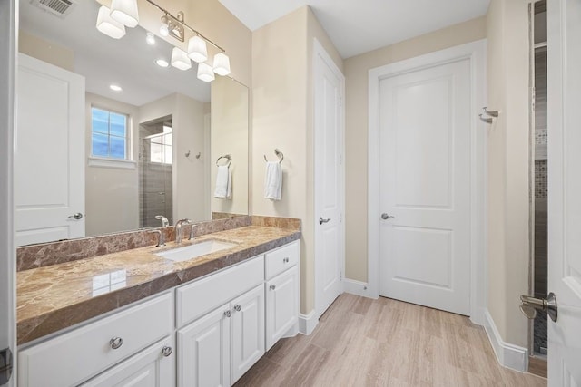 2319 Wyndam Heights Ln, Houston, TX 77077 - full bathroom with a shower stall, vanity, baseboards, and wood finished floors