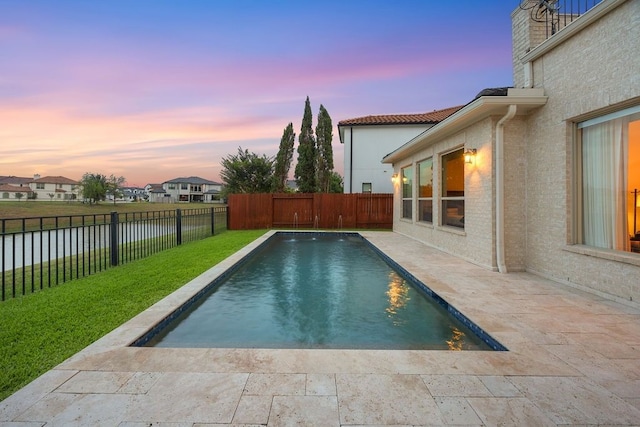 2319 Wyndam Heights Ln, Houston, TX 77077 - pool at dusk featuring a patio area and a water view