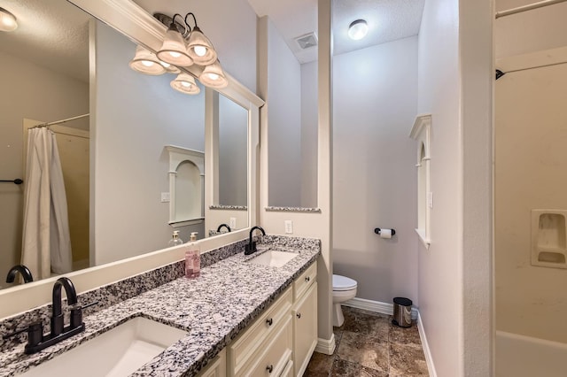 11519 Imperial Ln, Montgomery, TX 77316 - bathroom with toilet, double vanity, baseboards, a textured ceiling, and shower / bath combo with shower curtain