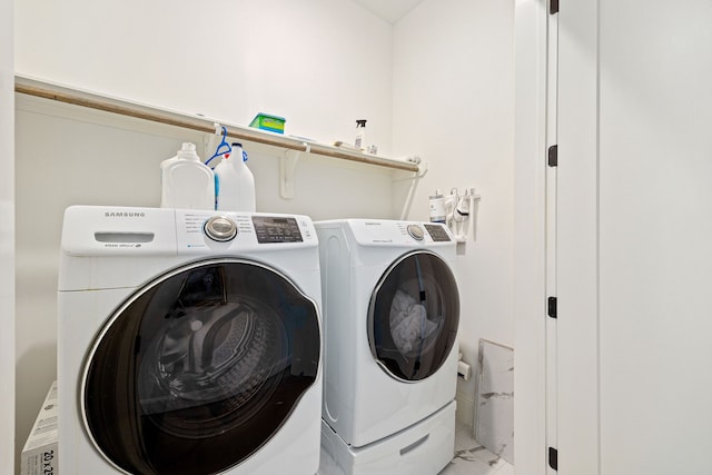 1433 Alexander St, Houston, TX 77008 - laundry area with washing machine and dryer and light marble finish floors