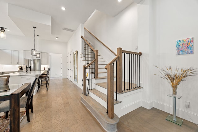 1433 Alexander St, Houston, TX 77008 - staircase with wood finished floors, baseboards, and recessed lighting