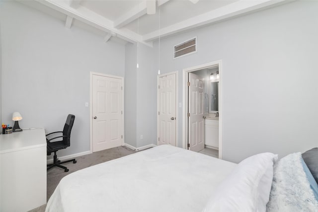 196 Barracuda St, Bayou Vista, TX 77563 - bedroom featuring a towering ceiling, carpet flooring, beam ceiling, baseboards, and connected bathroom