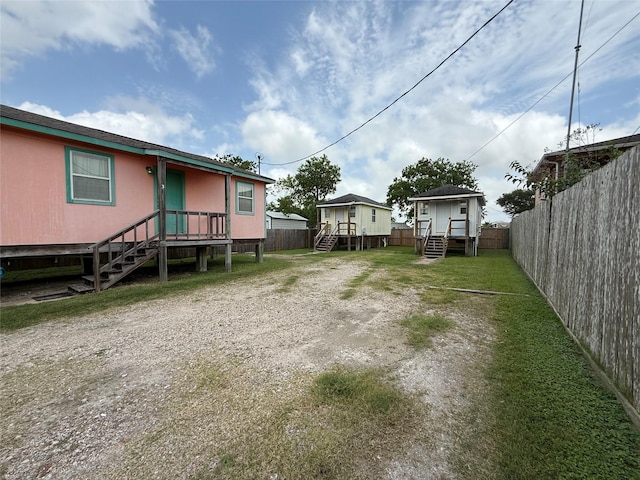 613 24th St, San Leon, TX 77539 - fenced backyard with stairs and a wooden deck