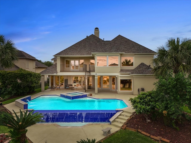2905 Sea Channel Dr, Seabrook, TX 77586 - rear view of property featuring a balcony, a patio area, roof with shingles, and stucco siding