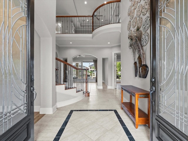 2905 Sea Channel Dr, Seabrook, TX 77586 - entrance foyer with a high ceiling, baseboards, arched walkways, recessed lighting, and stairway
