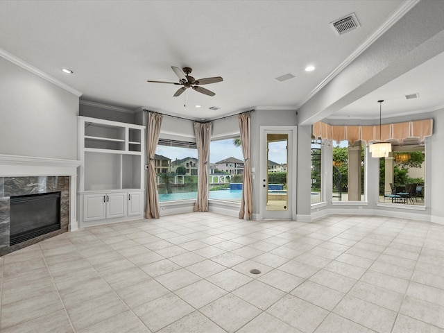 2905 Sea Channel Dr, Seabrook, TX 77586 - unfurnished living room with ceiling fan, tile patterned flooring, crown molding, recessed lighting, and a premium fireplace