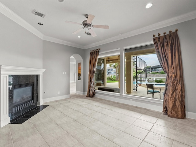 2905 Sea Channel Dr, Seabrook, TX 77586 - unfurnished living room with a ceiling fan, arched walkways, ornamental molding, a fireplace, and tile patterned flooring