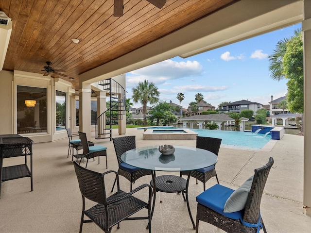 2905 Sea Channel Dr, Seabrook, TX 77586 - view of patio / terrace featuring ceiling fan, a pool with connected hot tub, stairs, outdoor dining space, and a residential view