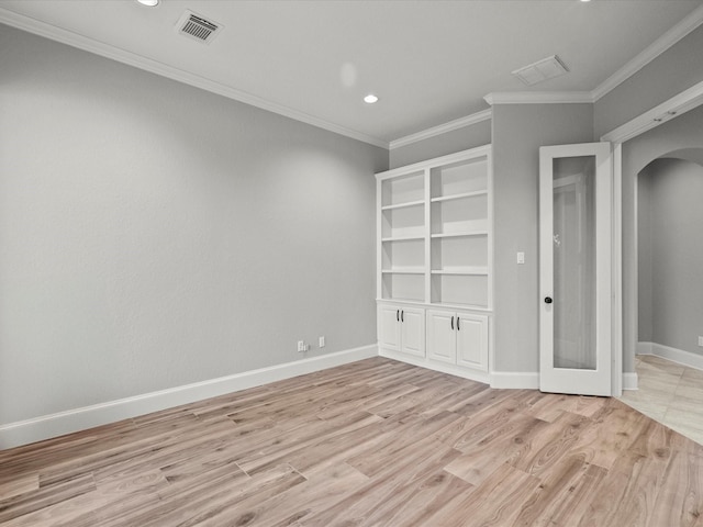 2905 Sea Channel Dr, Seabrook, TX 77586 - spare room with arched walkways, light wood-style flooring, ornamental molding, recessed lighting, and baseboards