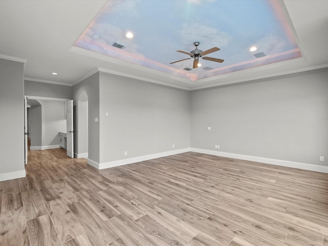 2905 Sea Channel Dr, Seabrook, TX 77586 - spare room with a raised ceiling, ceiling fan, arched walkways, ornamental molding, and light wood-style flooring