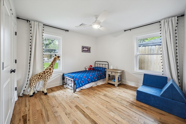 2218 Gardenia Dr, Houston, TX 77018 - bedroom featuring wood finished floors, multiple windows, baseboards, and a ceiling fan